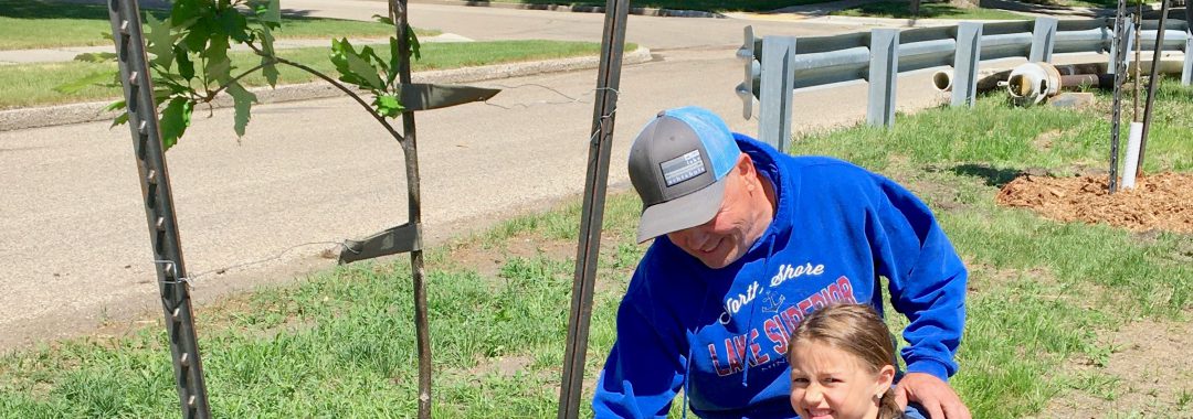 Rick Anderson and his granddaughter Emma Trapp, helped the Valley City Beautification Committee